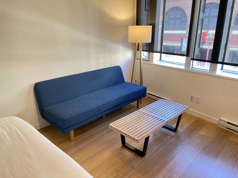 Couch, bench, and floor lamp