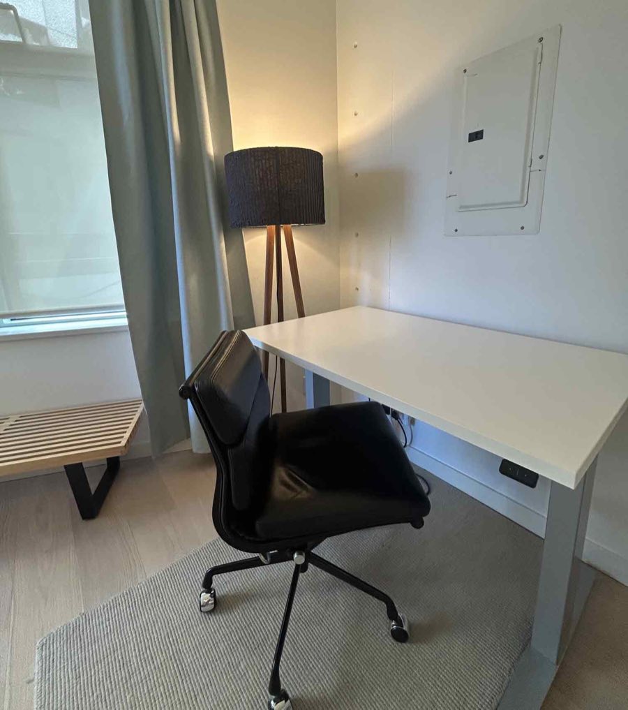 Desk, office chair, and floor lamp